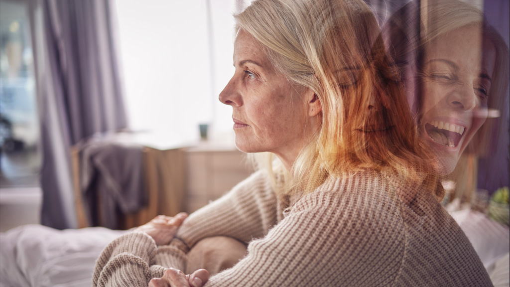 Woman sitting on a couch, representing the experience of living with bipolar disorder